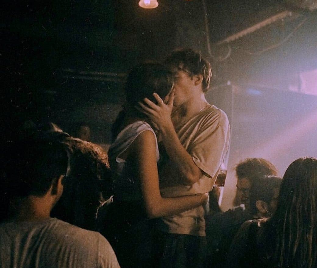 pareja besándose en fiesta